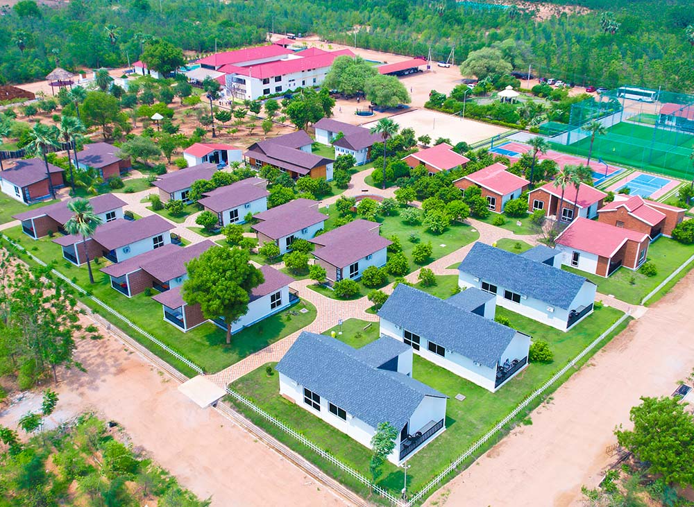 Top view of Go Ranch Resort cottages and rooms surrounded by greenery,offering single bedroom cottages, deluxe rooms, suite rooms, dormitories, and camping tents near Hyderabad