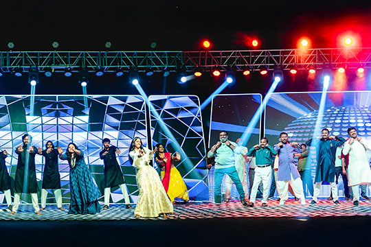 Sangeet ceremony at Go Ranch Resort with vibrant dance performances and dynamic stage lighting – perfect wedding event venue near Hyderabad