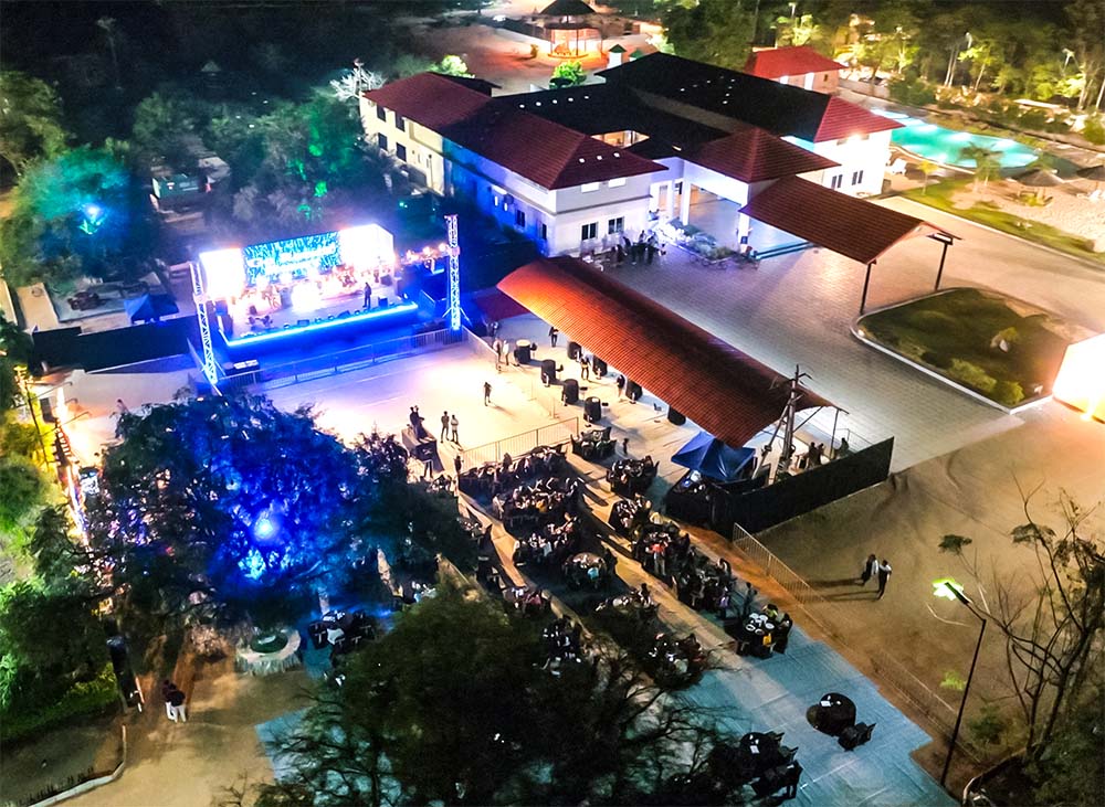 Night view of a grand outdoor event setup at Go Ranch Resort with stage lighting, ideal for large corporate gatherings, weddings, and business events near Hyderabad