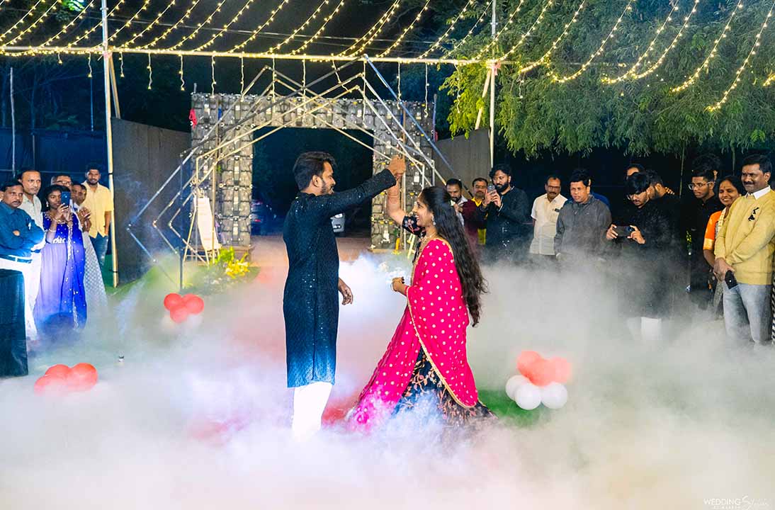 Couple dancing during a vibrant sangeet ceremony at Go Ranch Resort — the best resort for sangeet and mehndi ceremonies in Hyderabad, a luxury farm wedding resort.